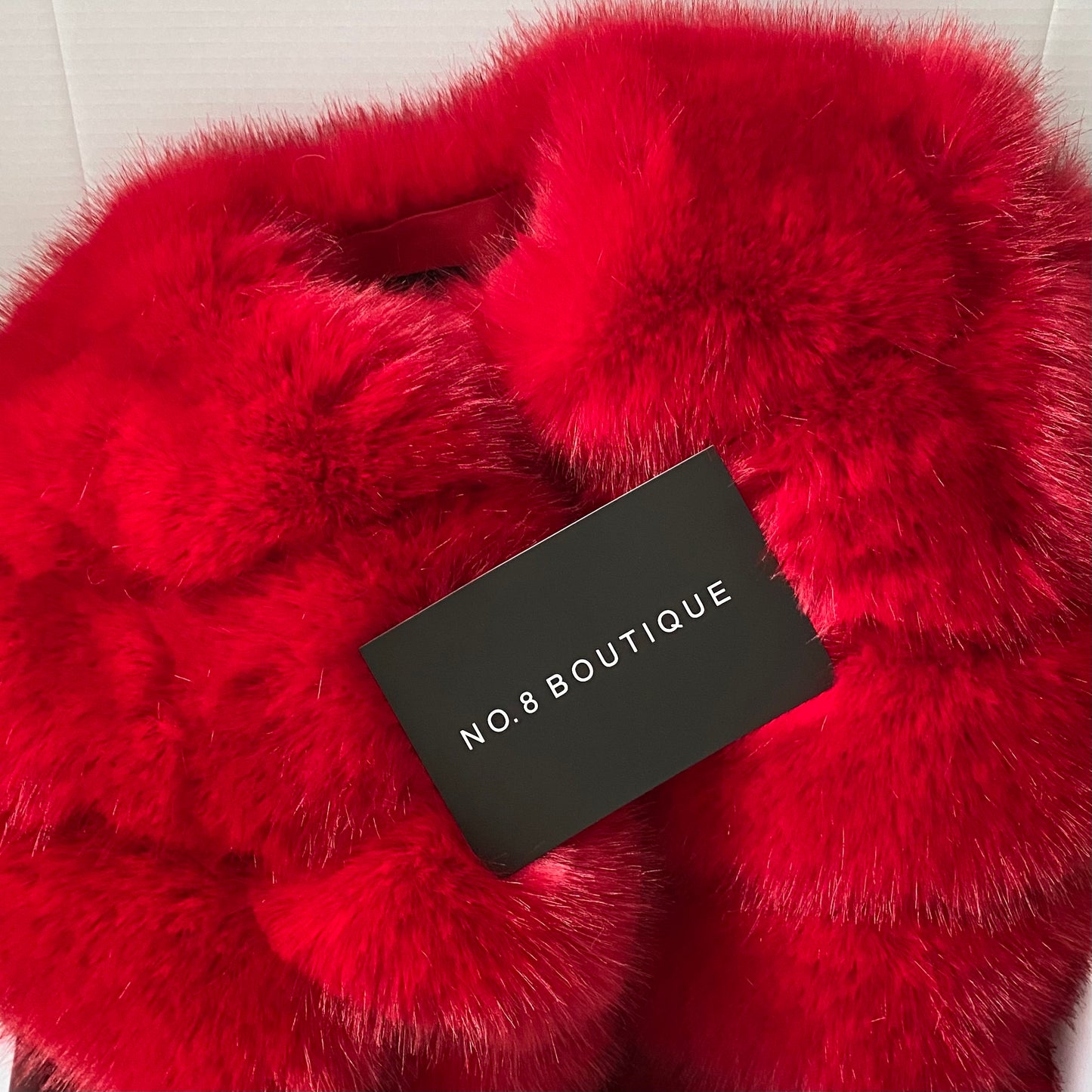 Bold red faux fur jacket with quintuple rows for a statement look