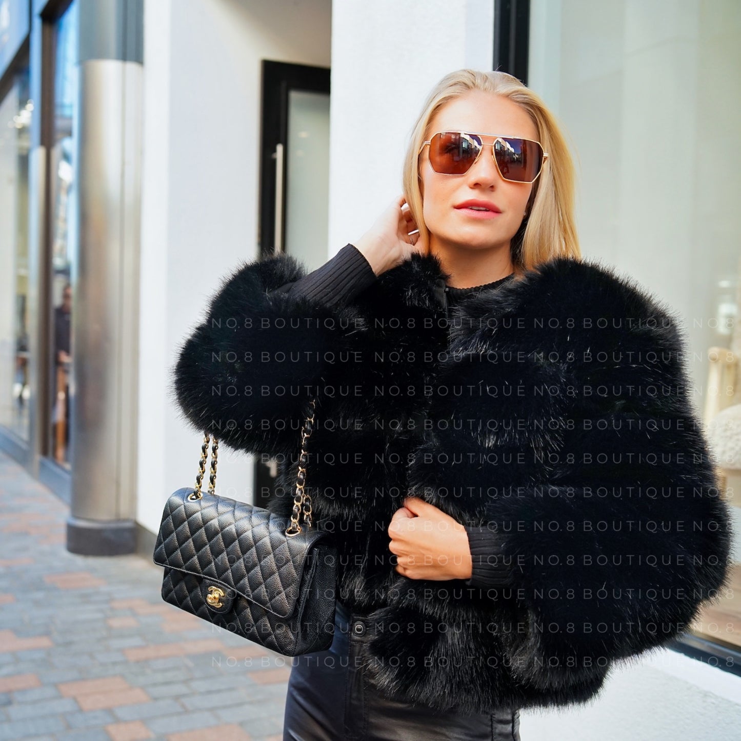 Fashionable black faux fur jacket with 5 rows