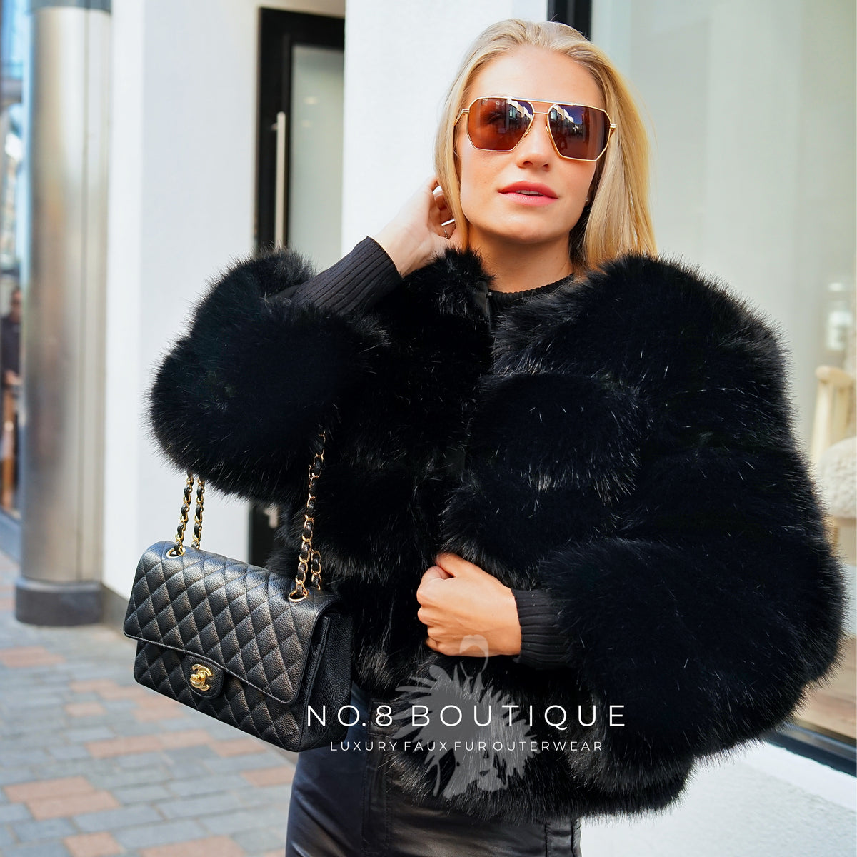 Luxury women's black faux fur jacket paired with evening outfit