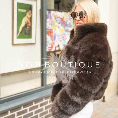 Elegant Chelsea faux fur jacket with three rows and cropped collar.