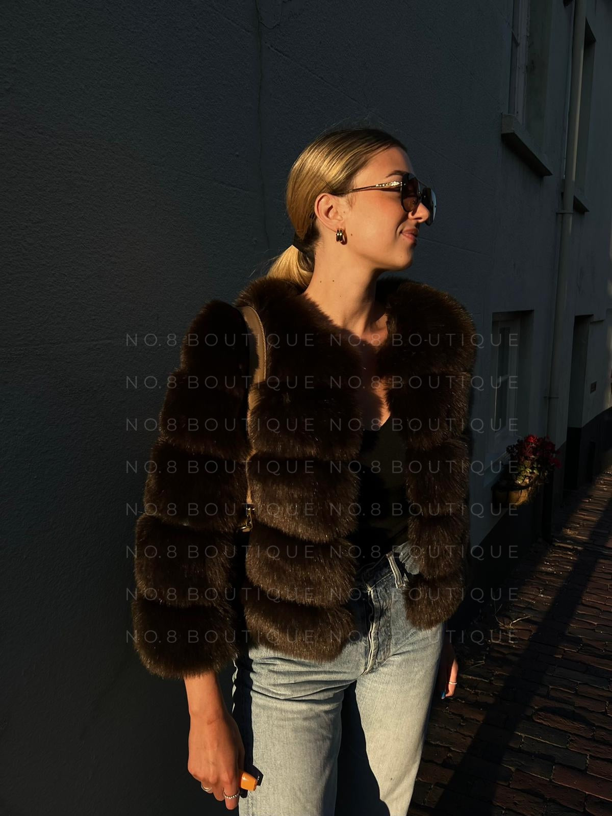 Fashion-forward coffee brown faux fur jacket with five luxurious rows