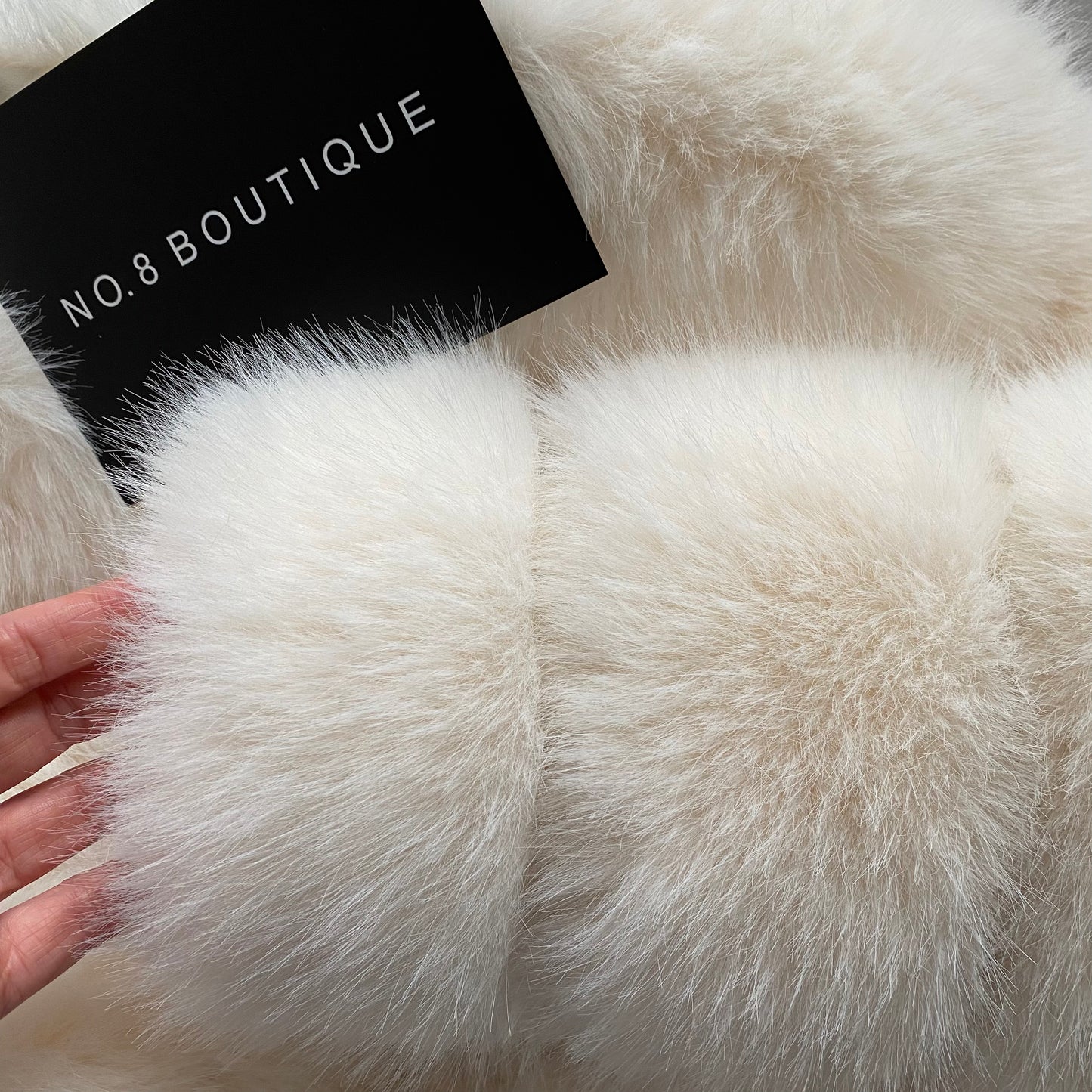 Plush white faux fur coat with seven-row design