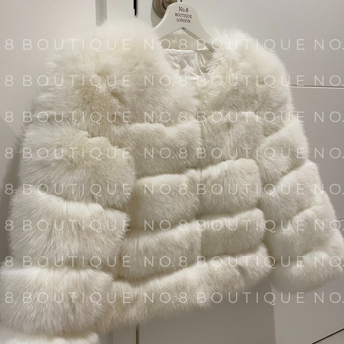 Designer white faux fur jacket with five structured rows